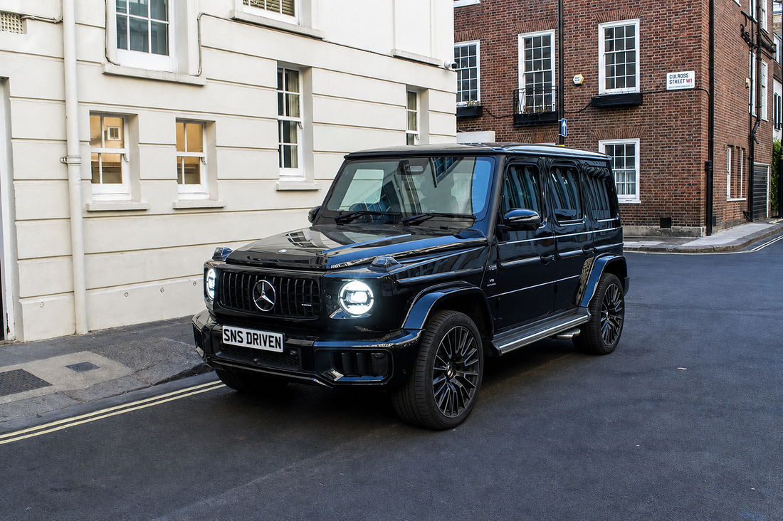 Black Mercedes-AMG G63, front three-quarter view on a quiet London street